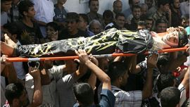 AFP - Palestinian mourners carry the body of Raid Sbetah during his funeral in Gaza City 30 August 2006. Six Palestinians were killed today by Israeli fire in the Gaza Strip, while the