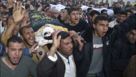 r - Palestinians carry the three bodies of militants killed by Israel troops in the refugee camp of Jenin April 21, 2007. Israeli troops shot and killed three