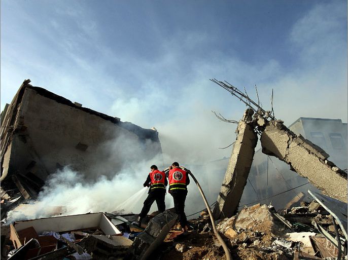 epa03472926 Palestinian firefighters try to extinguish a fire in a destroyed Hamas Ministry of Interior building after an Israeli air strike in Gaza City on, 16 November 2012. Missiles continue to be fired on Israeli targets by Palestinian militant in the Gaza Strip, as Israel continues to strike targets in retaliation inside the Gaza Strip, on the second day of Operation Pillar Cloud, following the assassination of Hamas militant leader Ahmed Jabari. Israeli forces launched a heavy barrage of bombs at the break of dawn but also announce a three hours ceasefire during the visit of the Egyptian Prime Minister Hesham Qandil in the Gaza Strip. EPA/MOHAMMED SABER