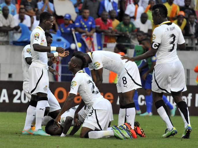 Ghana's midfielder Mubarak Wakaso (down) is congratulated by teammates after scoring a goal during the African Cup of Nation 2013 quarter final football match Ghana vs Cap Verde, on February 2, 2013 in Port Elizabeth. AFP PHOTO / ISSOUF SANOGO