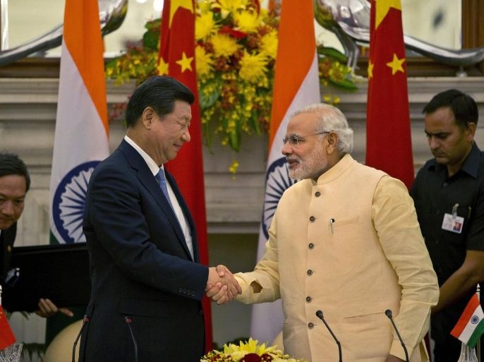 Chinese President Xi Jinping shakes hands with Indian Prime Minister Narendra Modi, right after signing agreements in New Delhi, India, Thursday, Sept. 18, 2014. Xi vowed to bring prosperity to Asia and create opportunities for the world as he and Modi began talks Thursday to deepen cooperation through investment and trade. (AP Photo /Manish Swarup)