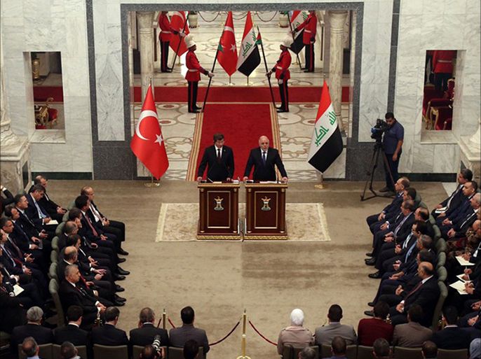A handout picture made available by the Iraqi Prime Minister's Office on November 20, 2014 shows Iraq's Prime Minister Haidar al-Abadi (R) shaking hands with his Turkish counterpart Ahmet Davutoglu in Baghdad. Davutoglu was given an official welcome at the main palace in the heavily fortified Green Zone, after which he held talks with Abadi, the Iraqi premier's office said, without providing further details. AFP