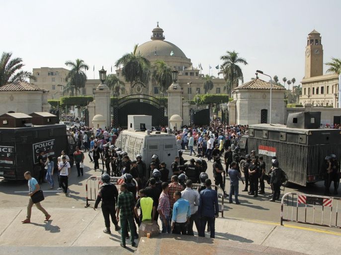 Egyptian security forces stand guard at Cairo University in Cairo, Egypt, Sunday, Oct. 12, 2014. Security officials said police backed by armored vehicles have stormed the campuses of at least two prominent Egyptian universities to quell anti-government protests by students. Sunday's largest rallies took place at Cairo and the Islamist al-Azhar universities. They were organized by supporters of ousted Islamist President Mohammed Morsi. (AP Photo/El Shorouk, Aly Hazzaa) EGYPT OUT
