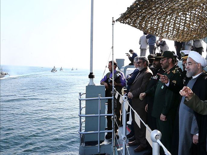 epa04543387 A handout picture made available by the presidential official website shows Iranian President Hassan Rowhani (R) attending the navy parade during a military drill in the Oman Sea, port city Bandar Jask southern Iran, 31 December 2014. Iran's national army has held a military drill near the Strait of Hormuz at the entrance to the Persian Gulf. EPA/PRESIDENTIAL OFFICIAL WEBSITE/HANDOUT HANDOUT EDITORIAL USE ONLY/NO SALES