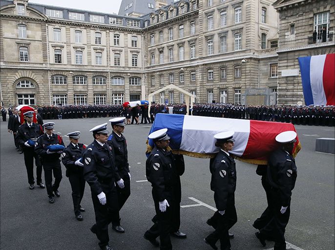 Police officers carry the coffins draped in the French flag of the three Police officers killed in the recent Islamist attacks, on January 13, 2015
