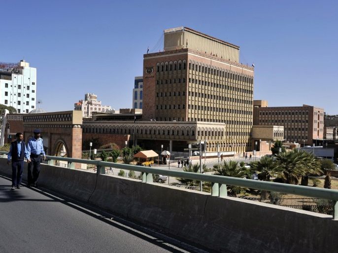 A picture made available on 29 November 2014 shows two Yemeni policemen patrolling on a bridge in front of the headquarters of the Central Bank of Yemen, in Sana'a, Yemen, on 04 November 2014. According to figures released by the Central Bank of Yemen, the country's external debt stood at 7.25 billion US dollar in September 2014, down some 128 million US dollar from last August. The Central Bank of Yemen reported also that international financing organizations make up the largest creditors with collective loans worth 3.6 billion US dollar.