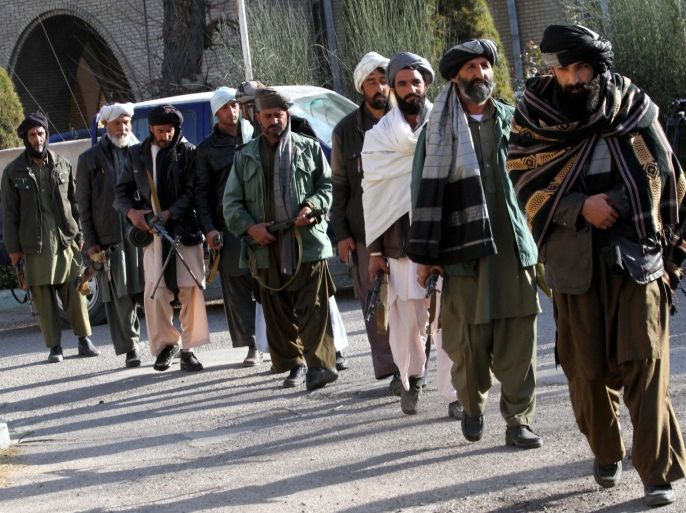 Former Taliban militants surrender their weapons during a reconciliation ceremony in Ghorian district of Herat, Afghanistan, 18 January 2015. A group of ten former Taliban militants on 18 January laid down their arms in Herat and joined the peace process. Under an amnesty launched by the former President Hamid Karzai and backed by the US in November 2004, hundreds of anti-government militants have so far surrendered to government.