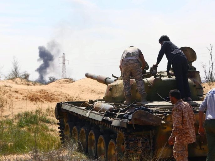 A Libyan militia in command of a tank clashes with rivals near Bir al-Ghanam, 90 km north of Tripoli, Libya, 19 march 2015. According to local reports one member of a militia blew himself up in clashes which claimed the lives of nine and left 14 wounded from both sides, as fighting continues in the war torn country, in which a senior commander from a group which has pledged allegiance to the group calling themselves the Islamic State (IS), Tunisian Ahmed Rouissi, was killed 17 March, and as the situation in Libya is expected to be discussed at an EU Heads of government meeting taking place in Brussels.