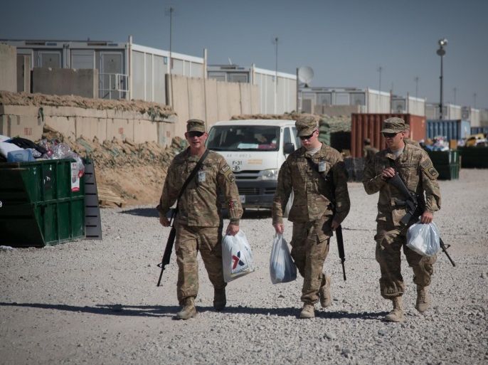 KANDAHAR, AFGHANISTAN - NOVEMBER 14: US Army troops pass an accommodation block at Kandahar airfield on November 14, 2014 in Kandahar, Afghanistan. Now that British combat operations have ended and the last UK base in Afghanistan had been handed over to the control of Afghan security forces, any remaining troops are leaving the country via Kandahar. As the drawdown of the US-led coalition troops heads into its final stages, many parts of Kandahar airfield, once home to tens of thousands of soldiers and contractors, are being closed or handed over to the Afghans.