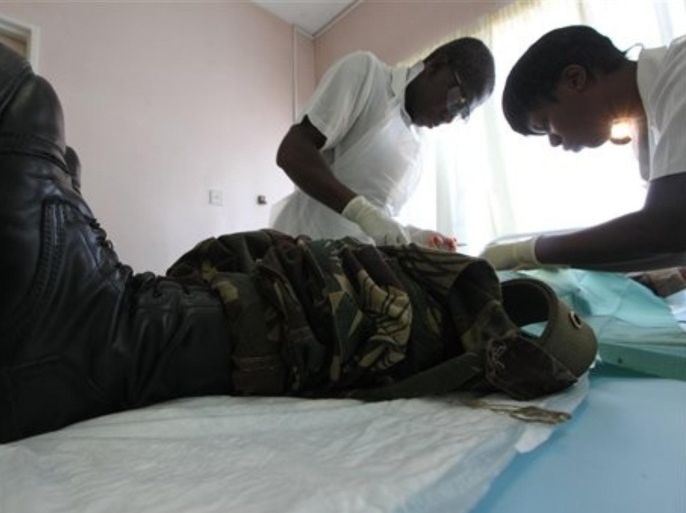 In this Oct. 28, 2010 photo, a doctor and a nurse perform a circumcision procedure on a Zimbabwean soldier at a local clinic in Harare, Zimbabwe. The U.S. Agency for International Development is leading a war on AIDS that may help save hundreds of thousands of Zimbabweans by funding male circumcision, considered a significant reducer of AIDS transmission. If the program can circumcise 1.2 million Zimbabwean men by 2017, 750,000 new HIV infections can be averted, said Dr. Bill Jansen, a senior American adviser with USAID.