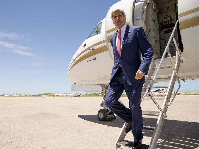 US Secretary of State John Kerry disembarks from his plane as he arrives at the airport in Mogadishu on May 5, 2015. John Kerry made a surprise trip to Somalia,