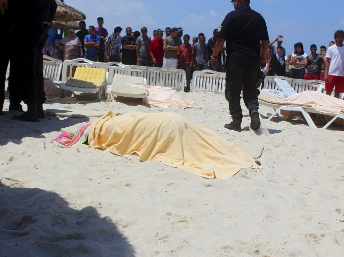 ATTENTION EDITORS - VISUAL COVERAGE OF SCENES OF DEATH AND INJURY The body of a tourist shot dead by a gunman lies near a beachside hotel in Sousse, Tunisia June 26, 2015. At least 27 people, including foreign tourists, were killed when at least one gunman opened fire on the Tunisian beachside hotel in the popular resort of Sousse on Friday, an interior ministry spokesman said. Police were still clearing the area around the Imperial Marhaba hotel and the body of one gunman lay at the scene with a Kalashnikov assault rifle after he was shot in an exchange of gunfire, a security source at the scene said. REUTERS/Amine Ben Aziza