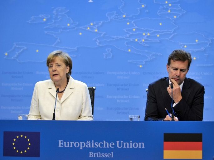 German Chancellor Angela Merkel (L) holds a press conference at the end of talks over the Greek debt crisis in Brussels on July 13, 2015. EU President Donald Tusk said that eurozone leaders had reached a unanimous deal to offer Greece a third bailout and keep it in the euro after 17 hours of marathon talks. AFP PHOTO / JEAN-CHRISTOPHE VERHAEGEN