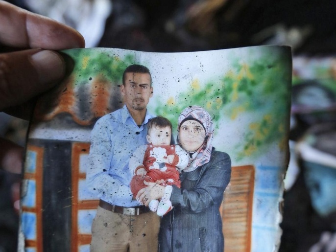 (FILE) A file photo dated 31 July 2015 of a scorched photograph of 18-month-old infant Ali Dawabsha (C) with his parents found in their fire damaged home in the village of Douma near Nablus City in the West Bank. The father of the Palestinian infant killed in firebomb attack by suspected Jewish extremist in the West Bank has died of his injuries at an Israeli hospital, Palestinians said on 08 August. Mosques in the village of Douma, south of the city of Nablus, announced the death of Saad Dawabsha, 37, on loudspeakers. His 18-month-old son Ali died in the arson attack on 31 July, his wife and son Ahmad, 4, are being treated for serious burns in Israel.