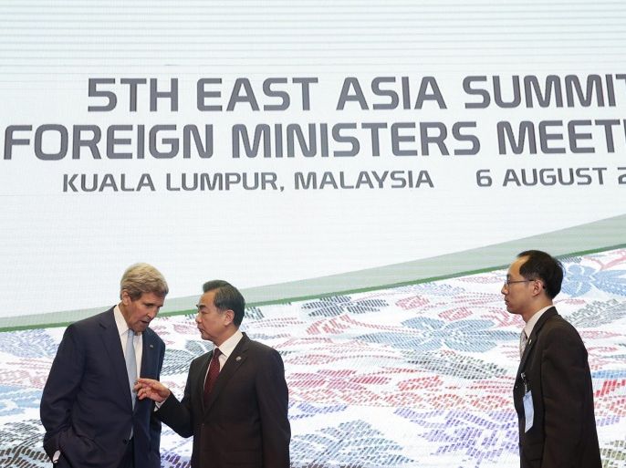 US Secretary of State, John Kerry (L) has a chat with China's Foreign Minister Wang Yi (2-L) after the family photograph during the 5th East Asia Summit Foreign Minister Meeting at the Putra World Trade Centre in Kuala Lumpur, Malaysia, 06 August 2015. Foreign ministers and leaders of the 10-member nation group, plus ministers from its international dialogue partners of China, South Korea, North Korea, Japan, India, Canada, Russia and the US, are to meet until 06 August to talk about regional security issues, including human trafficking and China's actions and disputes in the South China Sea territory.
