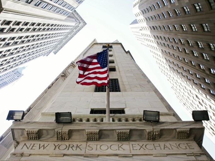 A U.S. flag hangs above an entrance to the New York Stock Exchange August 26, 2015. Wall Street racked up its biggest one-day gain in four years on Wednesday as fears about China's economy gave way to bargain hunters emboldened by expectations the U.S. Federal Reserve might not raise interest rates next month. REUTERS/Lucas Jackson