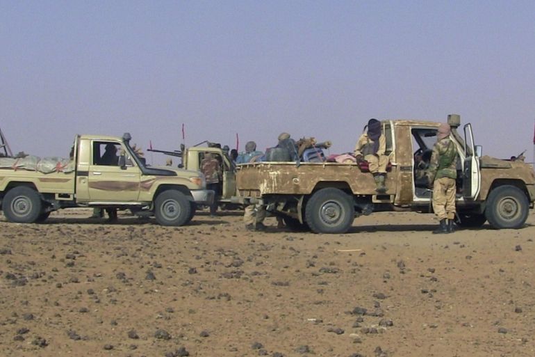 Fighters from the Tuareg separatist rebel group MNLA drive in the desert near Tabankort, February 15, 2015. Mali's government and Tuareg-led rebels resumed U.N.-sponsored peace talks in Algeria on Monday in pursuit of an accord to end uprisings by separatists seeking more self-rule for the northern region they call Azawad. Picture taken February 15, 2015.  REUTERS/Souleymane Ag Anara (MALI - Tags: MILITARY CONFLICT POLITICS)