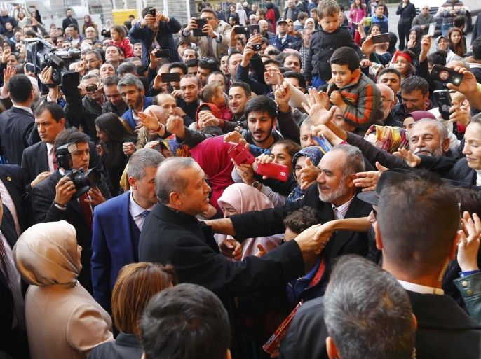 Turkish President Tayyip Erdogan shakes hands with his supporters after voting at a polling station in Istanbul, Turkey November 1, 2015. Turks began voting on Sunday amid worsening security and economic worries in a snap parliamentary election that could profoundly impact the divided country's trajectory and that of President Tayyip Erdogan. The parliamentary poll is the second in five months, after the ruling AK Party founded by Erdogan failed to retain its single-party majority in June. REUTERS/Murad Sezer