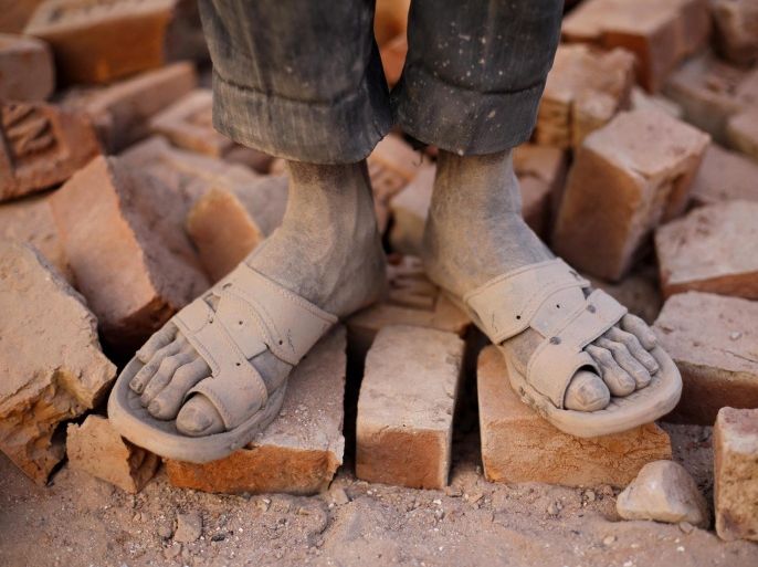 YEARENDER 2015 FEATURE PACKAGES(09/20) A Bangladeshi worker shows both of his dust-mixed feet in the brickfield in Habigonj, Bangladesh, 05 March 2015. About 11,000 brickfields are established across Bangladesh to meet the growing demand of construction works as urbanization rises rapidly in the country. Male and female poor laborers migrate to brickfields to find seasonal jobs despite the hard conditions and low salaries. EPA/ABIR ABDULLAH PLEASE REFER TO ADVISORY NOTICE (epa04726608) FOR FULL FEATURE TEXT