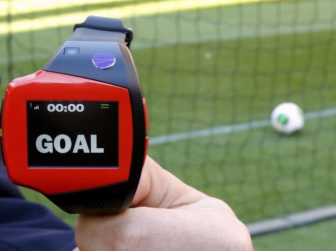 File photo of a FIFA official holding a wrist watch used as part of the Hawk-Eye goal-line technology at the Toyota Stadium in Toyota, central Japan December 8, 2012. The German DFL decided December 4, 2014 to use Hawk-Eye goal-line technology in the German first division Bundesliga soccer matches from next season. REUTERS/Toru Hanai/files (JAPAN - Tags: SPORT SOCCER SCIENCE TECHNOLOGY)