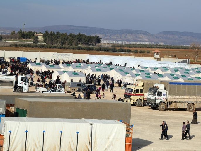 In this photo provided by Turkey's Islamic aid group of IHH, Syrians fleeing the conflicts in Azaz region, are seen at a temporary accommodation center set up by the group near the Bab al-Salam border gate, Syria, Friday, Feb. 5, 2016. Turkish officials say thousands of Syrians have massed on the Syrian side of the border seeking refuge in Turkey. Officials at the government’s crisis management agency said Friday it was not clear when Turkey would open the border to allow the group in and start processing them. The refugees who fled bombing in Aleppo, were waiting at the Bab al-Salam crossing, opposite the Turkish province of Kilis.(IHH via AP)