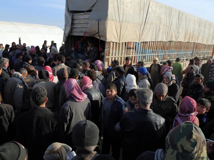 In this photo provided by Turkey's Islamic aid group of IHH, Syrians fleeing the conflicts in Azaz region, congregate at the Bab al-Salam border gate, Syria, Friday, Feb. 5, 2016. Turkish officials say thousands of Syrians have massed on the Syrian side of the border seeking refuge in Turkey. Officials at the government’s crisis management agency said Friday it was not clear when Turkey would open the border to allow the group in and start processing them. The refugees who fled bombing in Aleppo, were waiting at the Bab al-Salam crossing, opposite the Turkish province of Kilis.(IHH via AP)
