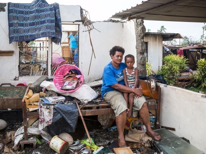 Fijian woman Kalisi holds her son Tuvosa, 3, as she sits on a bed in the remnants of her home damaged by Cyclone Winston in the Rakiraki District of Fiji's Ra province, in this February 24, 2016 handout picture provided by UNICEF. REUTERS/UNICEF-Sokhin/Handout via Reuters ATTENTION EDITORS - THIS PICTURE WAS PROVIDED BY A THIRD PARTY. REUTERS IS UNABLE TO INDEPENDENTLY VERIFY THE AUTHENTICITY, CONTENT, LOCATION OR DATE OF THIS IMAGE. FOR EDITORIAL USE ONLY. NOT FOR SALE FOR MARKETING OR ADVERTISING CAMPAIGNS. FOR EDITORIAL USE ONLY. NO RESALES. NO ARCHIVE. THIS PICTURE IS DISTRIBUTED EXACTLY AS RECEIVED BY REUTERS, AS A SERVICE TO CLIENTS.