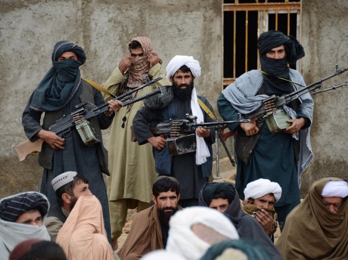 FILE - In this Nov. 3, 2015 file photo, Afghan Taliban fighters listen to Mullah Mohammed Rasool, the newly-elected leader of a breakaway faction of the Taliban, in Farah province, Afghanistan. Senior members of the Afghan Taliban said on Thursday that a prominent figure within the militant group who had opposed its new leadership has now pledged his allegiance, helping to close divisions within the Taliban ahead of possible peace talks with the government. (AP Photo, File)
