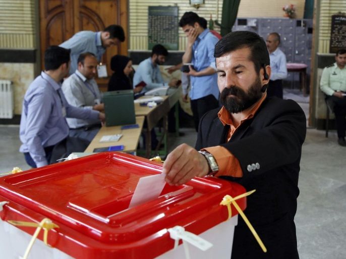An Iranian voter casts his ballot for the parliamentary runoff elections in a polling station at the city of Qods about 12 miles (20 kilometers) west of the capital Tehran, Iran, Friday, April 29, 2016. Iranians voted Friday in the country's parliamentary runoff elections, a key polling that is expected to decide exactly how much power moderate forces backing President Hassan Rouhani will have in the next legislature. The balloting is for the remaining 68 positions in the 290-seat chamber that were not decided in February's general election, in which Rouhani's allies won an initial majority. (AP Photo)