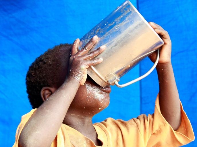 A newly arrived refugee child drinks inside their tent in Baley settlement near the Ifo extension refugee camp in Dadaab, near the Kenya-Somalia border, in Garissa County, Kenya July 27, 2011. REUTERS/Thomas Mukoya/File Photo