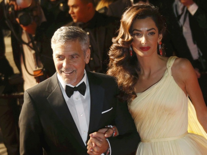 Cast member George Clooney and his wife Amal leave the Festival Palace after the screening of the film "Money Monster" out of competition at the 69th Cannes Film Festival in Cannes, France, May 12, 2016. REUTERS/Regis Duvignau