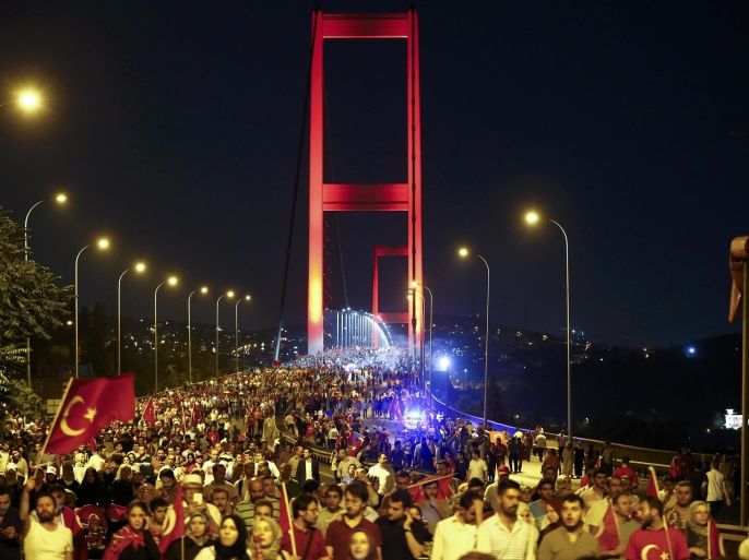 Pro-government demonstrators march over the Bosphorus Bridge, from the Asian to the European side of Istanbul, Turkey, July 21, 2016. REUTERS/Osman Orsal