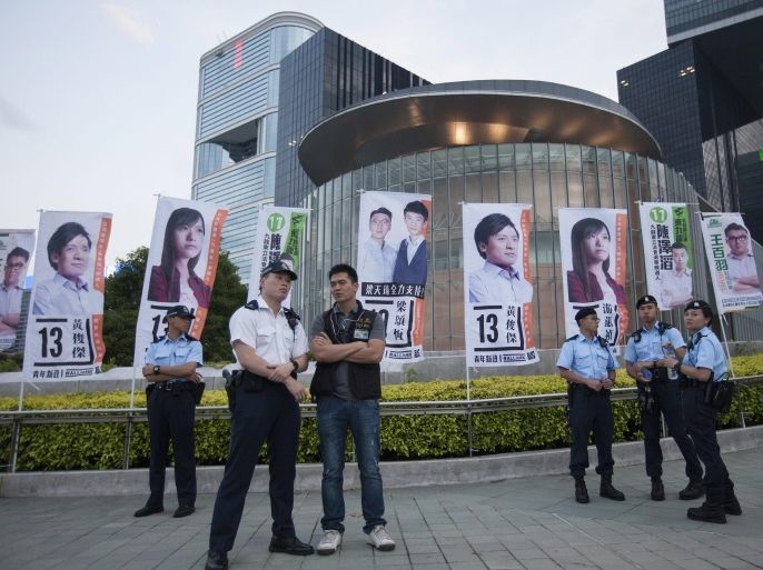 Police officers stand in front of the city's Legislative Council prior to an election rally by the Youngspiration political party, Hong Kong, China, 28 August 2016. Hong Kong election officers blocked five candidates from standing in the city’s Legislative Council Elections over questions about whether they acknowledged the city as an 'inalienable part' of China. Disqualified electoral candidate Edward Leung, who is Hong Kong's de facto independence leader, is supp