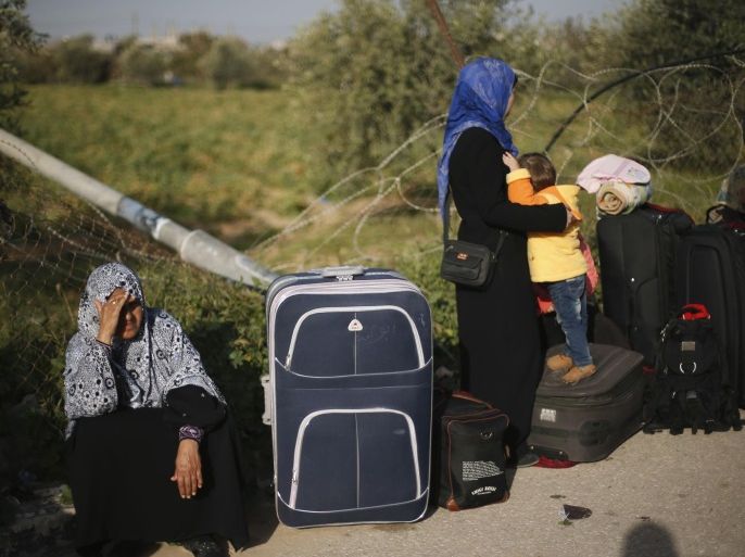 A Palestinian woman rests next to her suitcase as she waits for a travel permit to cross into Egypt, at the Rafah crossing between Egypt and the southern Gaza Strip March 9, 2015. Egyptian authorities opened the Rafah border crossing on Monday for two days, officials said. Rafah is the only major crossing between impoverished Gaza, home to 1.8 million Palestinians, and the outside world that does not border Israel, which blockades the strip and allows passage mainly on