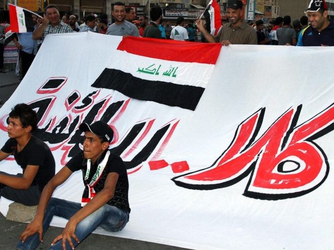 Young Iraqis sit infron of a banner reading in Arabic 'No to sectarianism' during a demonstration in Tahrir square, central Baghdad, Iraq, 28 August 2015. According to recent reports as part of a large number of measures enacted by Iraqi Prime Minister Haider al-Abadi designed to meet the demands of protesters, decrease graft and increase accountability of politicians security forces have been ordered to give more access to citizens to Baghdad's heavily fortified Green Zone.