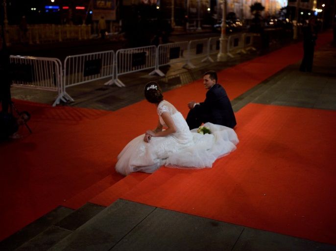 A couple poses for wedding photos on the red carpet at the San Sebastian Film Festival, September 18, 2016. REUTERS/Vincent West