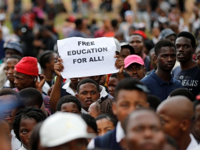 A protester holds up a placard as students gather outside South African President Jacob Zuma's offices demanding free university education, in Pretoria, South Africa October 20,2016. REUTERS/Siphiwe Sibeko