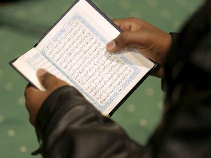 A man reads the Quran during Friday prayer service at the All Dulles Area Muslim Society in Sterling, Virginia December 18, 2015. REUTERS/Joshua Roberts