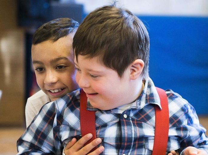 YEARENDER 2016 FEATURE PACKAGES(01/21) Nandor Szecsi (R), who has Down syndrome, is hugged by his classmate Zsolt Pintye in the classroom at the Vecsey Karoly Member Institute of Moricz Zsigmond Primary School in Nyiregyhaza, 245 kms east of Budapest, Hungary, 13 January 2016. Nandor Szecsi and Peter Pazmany, two boys with Down's syndrome, attend the first grade of the school that runs an integration program for children with disabilities. The parents of Nandor and Peter opted for this elementary school instead of a special needs education alternative to help their children develop social and cognitive skills in a regular school environment. EPA/ATTILA BALAZS PLEASE REFER TO THE ADVISORY NOTICE (epa05228565) FOR FULL PACKAGE TEXT HUNGARY OUT