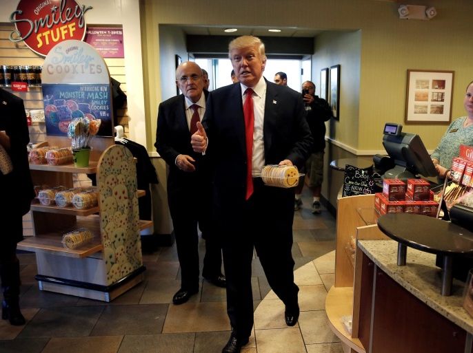 Republican U.S. presidential nominee Donald Trump and Former New York City Mayor Rudy Giuliani (Back L) make a stop to buy cookies at the Eat'n Park restaurant in Moon Township, Pennsylvania, October 10, 2016. REUTERS/Mike Segar