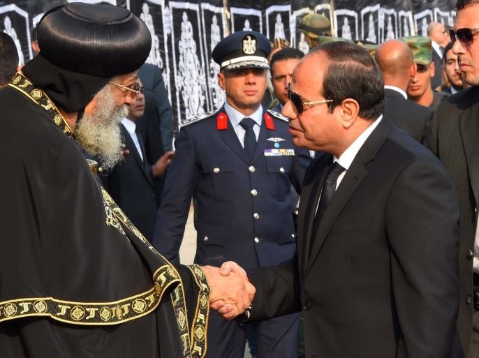 A handout picture made available by the Egyptian Presidency showing Egyptian President Abdel Fattah al-Sisi giving his condolonces to Pope Tawadros II of Alexandria, head of the Egyptian Coptic Orthodox Church, during the funeral service for the victims of the suicide bombing that killed 24 coptic christian, in front of the tomb of the unknown soldier, Cairo, Egypt, 12 December 2016. Egyptian President Abdel Fattah al-Sisi announced that 22-year-old suicide bomber named
