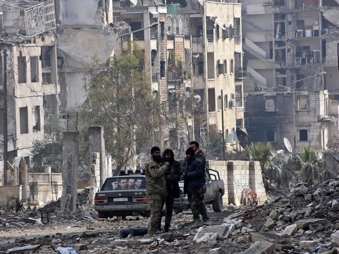 A handout photo made available by official Syrian Arab News Agency (SANA) shows unidentified armed men in the destroyed streets of Al-Sukari and Ansari district in Aleppo, Syria, 23 December 2016. The Syrian General Command of the Army and the armed forces on 22 December 2016 announced the return of security and safety to the city of Aleppo after its liberation. EPA/SANA / HANDOUT