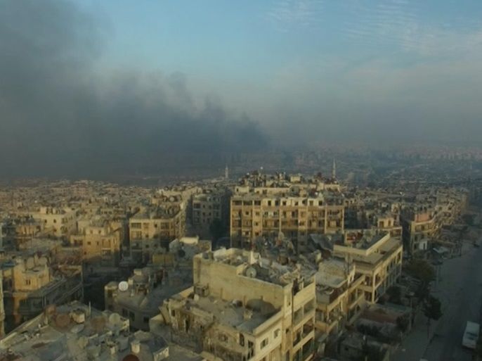 A still image from video taken December 12, 2016 of a general view of smoke rising over bomb damaged eastern Aleppo, Syria. Video released December 12, 2016. REUTERS/via ReutersTV