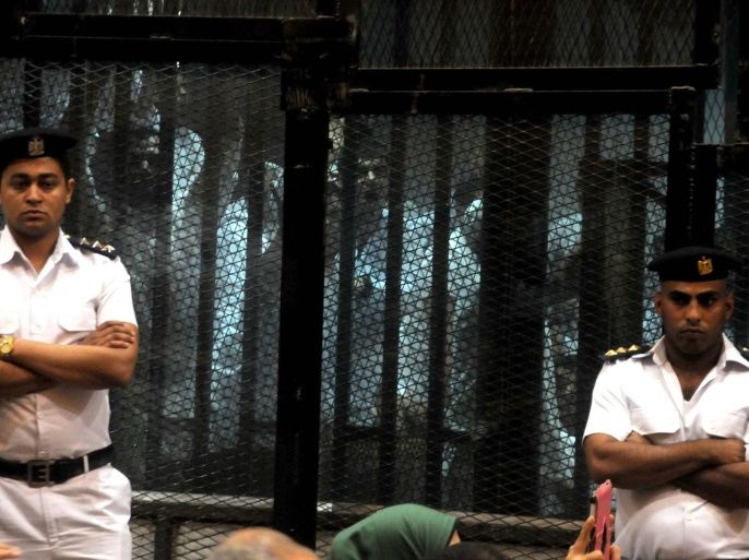 Egyptian members of the Muslim Brotherhood group stand behind bars during a trial session in Cairo, Egypt, 30 May 2016. A court sentenced Muslim Brotherhood leader Mohamed Badie and 35 other defendants to life in prison over charges of inciting violence in 2013. The court also sentenced 48 members of the group to jail terms. EPA/TAREK WAJEH EGYPT OUT