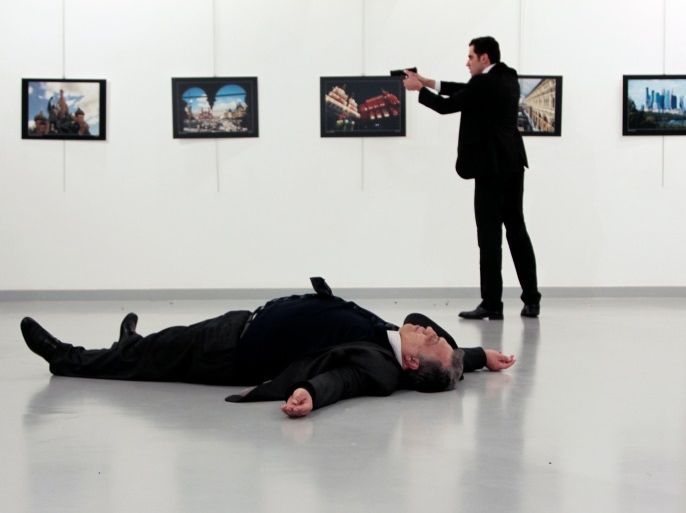 ATTENTION EDITORS - VISUAL COVERAGE OF SCENES OF DEATH Russian Ambassador to Turkey Andrei Karlov lies on the ground after he was shot by unidentified man at an art gallery in Ankara, Turkey, December 19, 2016. Hasim Kilic/Hurriyet via REUTERS ATTENTION EDITORS - THIS PICTURE WAS PROVIDED BY A THIRD PARTY. FOR EDITORIAL USE ONLY. NO RESALES. NO ARCHIVE. TURKEY OUT. NO COMMERCIAL OR EDITORIAL SALES IN TURKEY.
