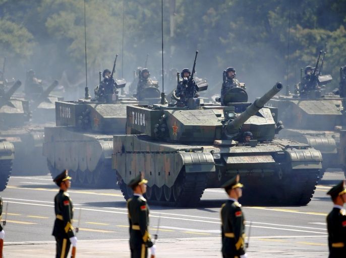 Armoured vehicles drive past paramilitary policemen during the military parade marking the 70th anniversary of the end of World War Two, in Beijing, China, in this September 3, 2015 file picture.China has almost doubled its weapons exports in the past five years, a military think tank said on Monday, as the world's third-largest weapons exporter pours capital into developing an advanced arms manufacturing industry. REUTERS/Damir Sagolj/Files