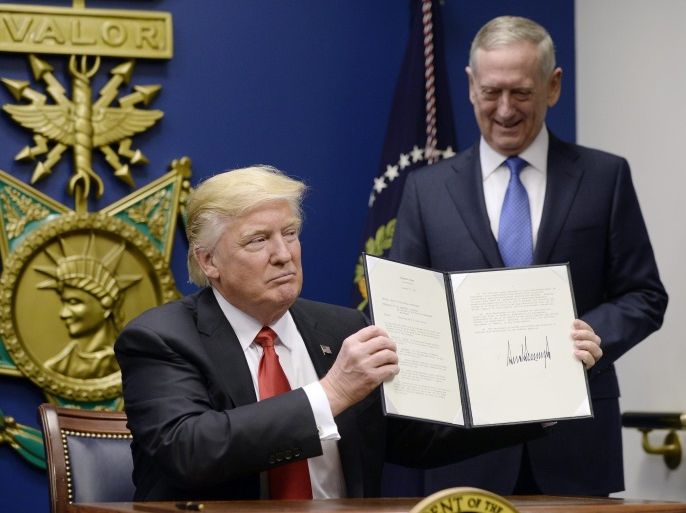 US President Donald J. Trump signs Executive Orders in the Hall of Heroes at the Pentagon in Arlington, Virginia, USA, 27 January 2017, as newly sworn-in US Secretary of Defense James Mattis (R) looks on.