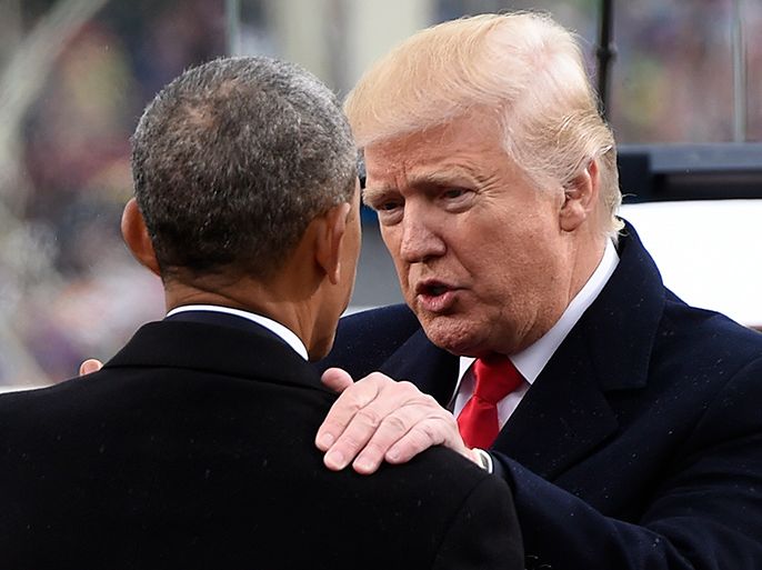 epa05735622 New US President Donald J. Trump (R) speaks with former President Barack Obama (L, back to camera) after his inauguration as the 45th President of the United States at the US Capitol in Washington, DC, USA, 20 January 2017. Trump won the 08 November 2016 election to become the next US President. EPA/SAUL LOEB / POOL