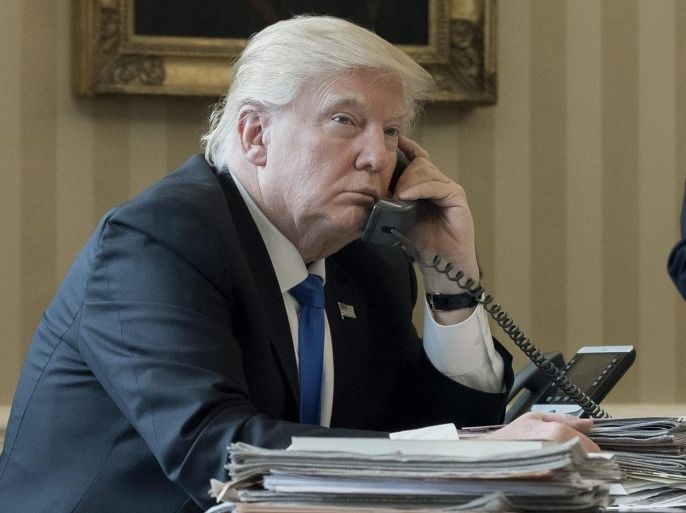 US President Donald J. Trump (L) speaks on the phone with President of Russia Vladimir Putin, with White House Chief of Staff Reince Priebus (R) behind, in the Oval Office of the White House in Washington, DC, USA, 28 January 2017. President Trump has chosen the day to talk with different world leaders, significantly Russia's Vladimir Putin and Germany's Angela Merkel by telephone.