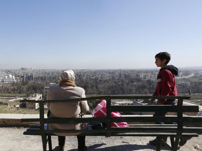 People sit on a bench and look at Aleppo, northern Syria, 02 February 2017. The Syrian army recaptured last month the eastern neighborhoods of Aleppo that were held by gunmen for more than four years.